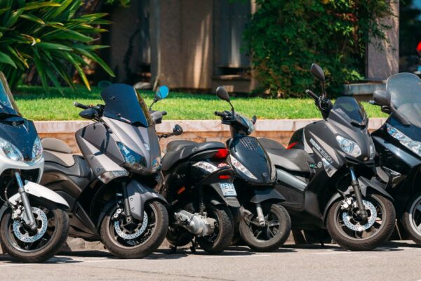 Motorbike, motorcycle scooters parked in row in city street Monte-Carlo, Monaco - June 28, 2015: Motorbikes, motorcycles scooters parked in row in city street